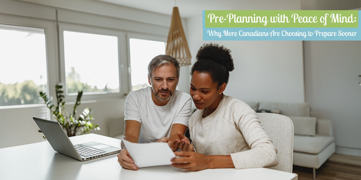Middle-aged couple reviewing funeral pre-planning documents together at home, highlighting the importance of early cremation planning in Ontario.