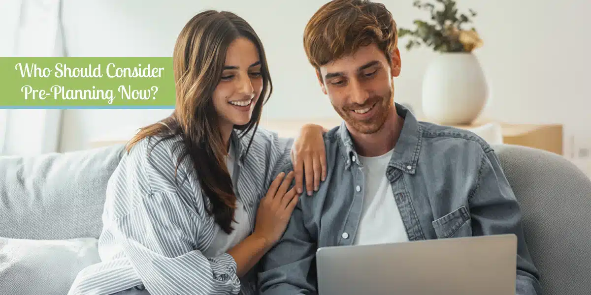 Young couple smiling while exploring funeral pre-planning options online, representing proactive end-of-life planning for Ontario families.